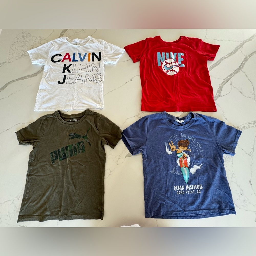5 T-shirts (Puma, Calvin Klein, Nike, Earth Nymph).
